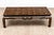 A low rectangular Chinese-style coffee table in a dark crazed and lacquered finish with a top decorated in gilt and rust-...