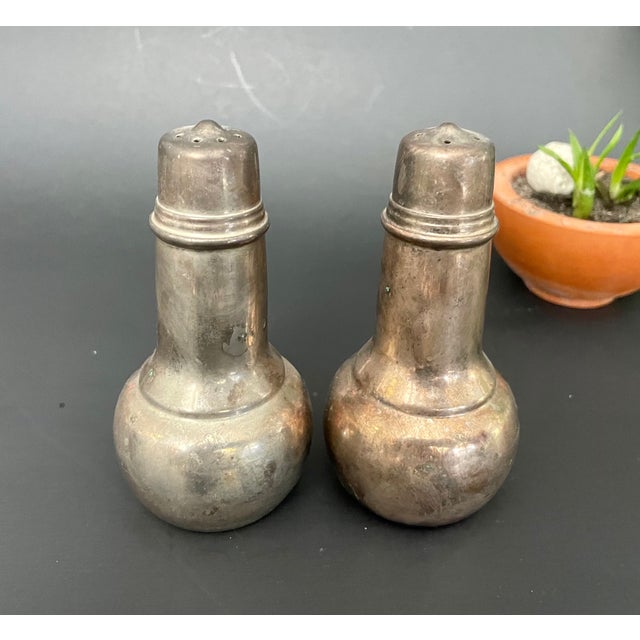 Wonderful vintage pair of silver-plated salt and pepper shakers by International Silver, dating to the 1950s. With their...
