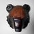Expressive carved wooden bear head made as a wall piece. The fur is worked with short, rhythmic gouge marks, with a...