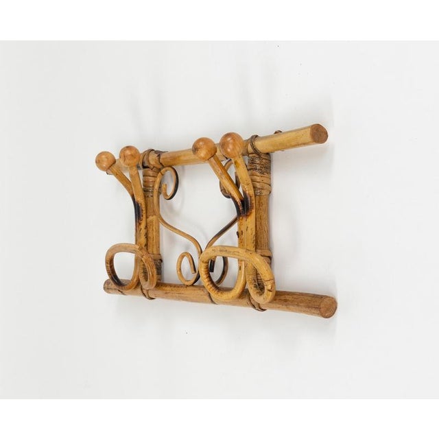 Midcentury beautiful wall coat rack in bamboo and rattan in the style of Olaf von Bohr. Made in Italy in the 1960s.