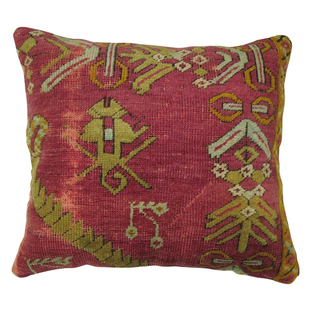 Pillow made from a 19th century Turkish Ghiordes rug backed in red cotton. Measures: 16'' x 18''.