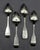 Set of four coin silver place spoons by G.O. Conrad, mid-19th century. Fiddle pattern; well pointed tips; script monogram...