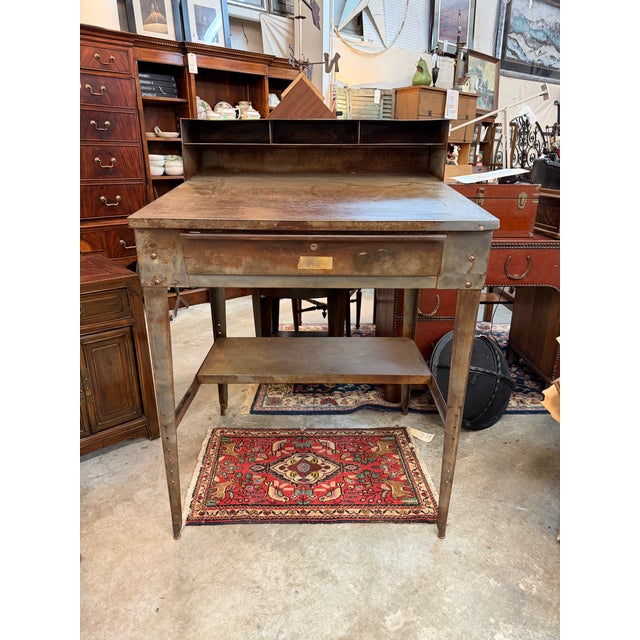 This mid-20th century industrial shop desk and matching stool set, displays pure machine-age utility. Built to endure a...