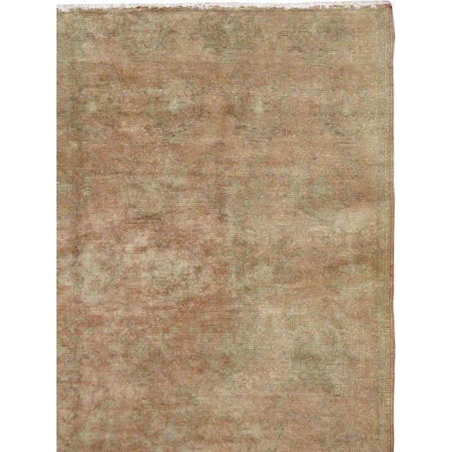 This mid-20th-century Turkish Anatolian accent rug presents an exceptionally subdued composition in warm sand, camel,...