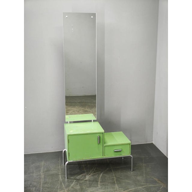 Original Bauhaus dressing table combining lacquered beech, plywood construction, chrome-plated tubular steel elements, and...