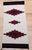 This vintage Native American Navajo area rug, woven circa the mid-20th century, features a striking triple medallion...