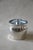 A lidded silverplate ice bucket by International Silver Co. in the Countess pattern, with a fitted glass liner that keeps...