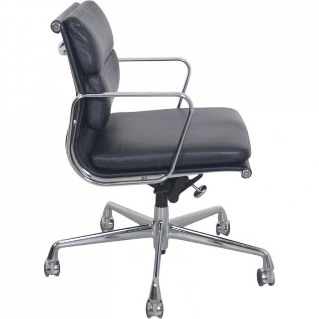Charles Eames EA-217 office chair upholstered in black leather, and with chrome armrests and base. The chair is from 2011...