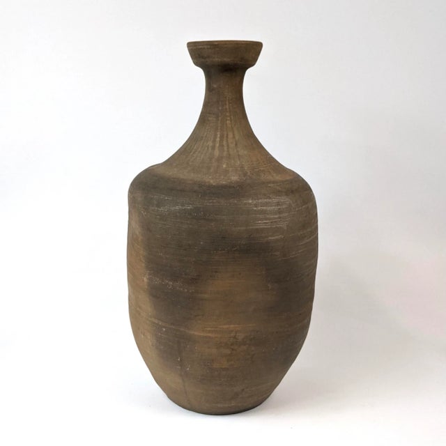 A pair of beautiful rustic vases with an organic shape. This would be great for flowers or to be made into a pair of lamps
