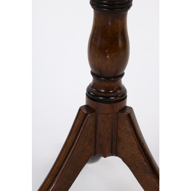 Regency Period Duet Stand in Walnut circa 1820; tripod base supports a turned column with ebonized details. At the top of...