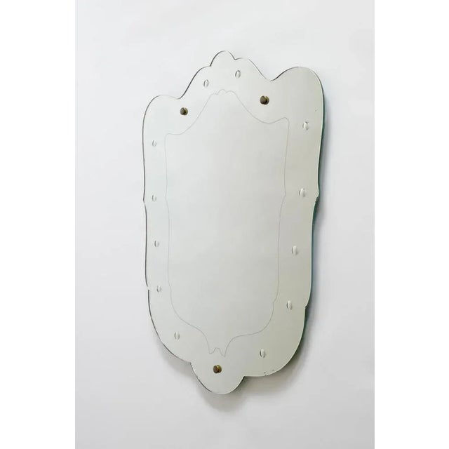 Unique sculptural italian 1940s mirror. An imposing shield and sinuous shaped etched mirror of imposing size. A fine...