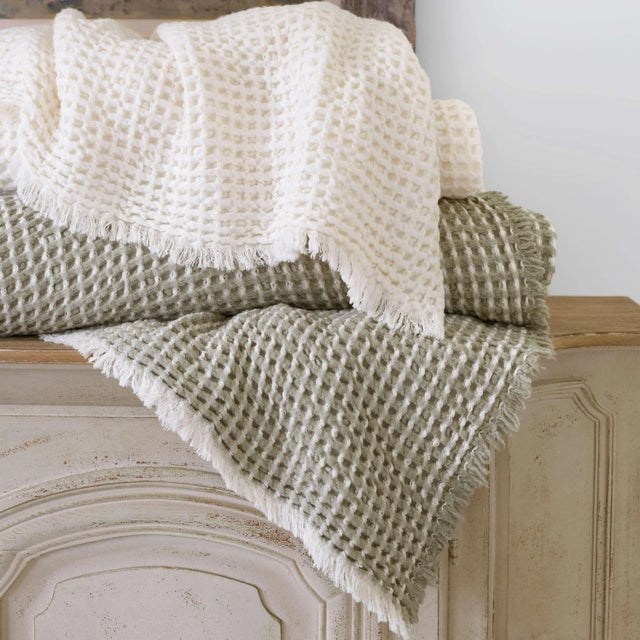 Warm and inviting, this extra layer for your bed is lofty, frothy, and woven in Portugal to look and feel like the softest...
