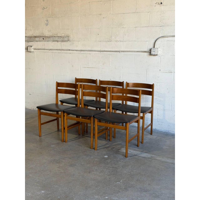 This set of six dining chairs showcases clean lines and organic craftsmanship. Crafted in Denmark from rich teak wood...