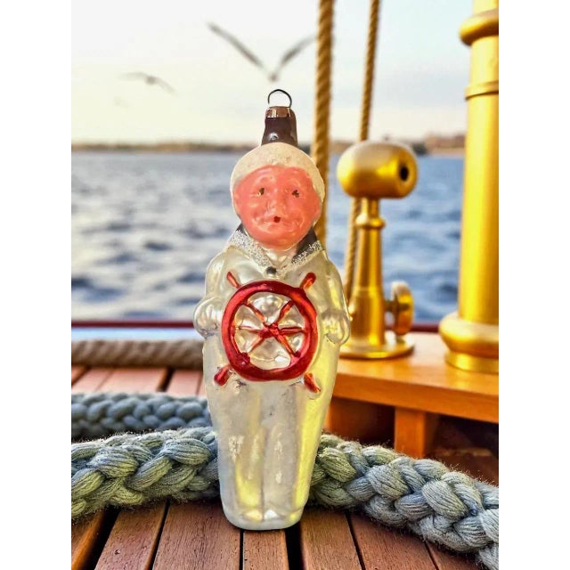 An East German (GDR) hand-blown glass ornament in the form of a fisherman or sailor, produced mid-20th century (c....
