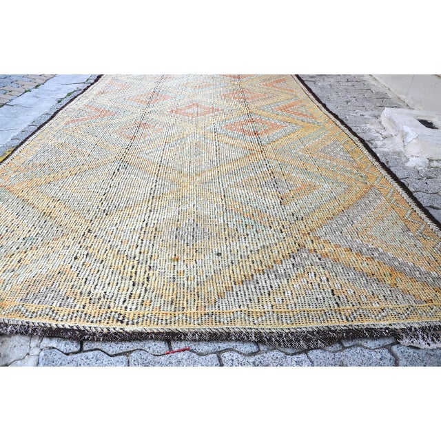This is a vintage Turkish Anatolian kilim rug from the 1960s. The piece was hand-woven.
