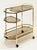 A fine Italian Modern bar cart or console drinks cart of brass and smoked glass, featuring two octagonal glass tiers and...