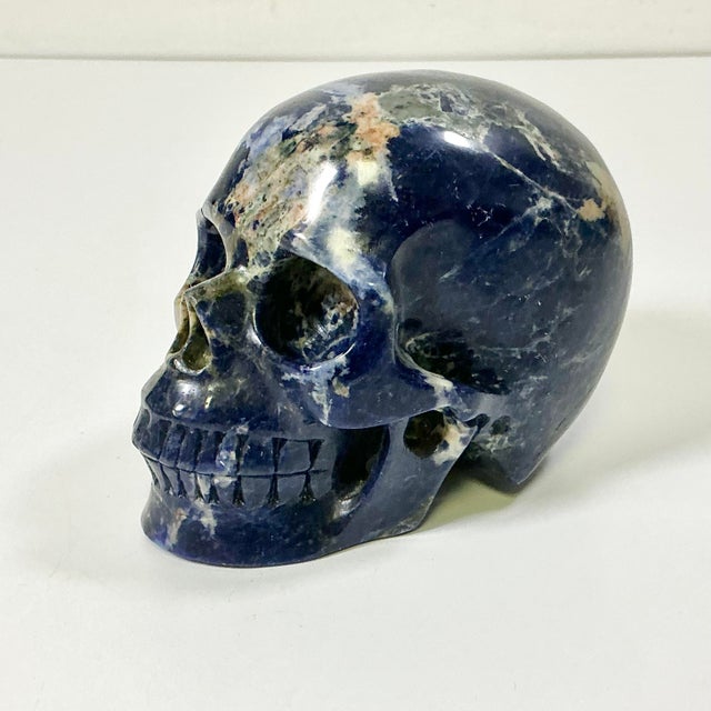 Vintage Home is pleased to offer this hand carved Skull Sculpture. It’s carved from Sodalite. The stone is a deep navy...