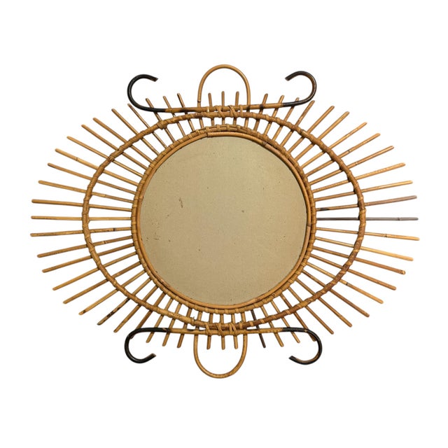 1950s rattan sunburst mirror. The mirror is original. Made in southern France.