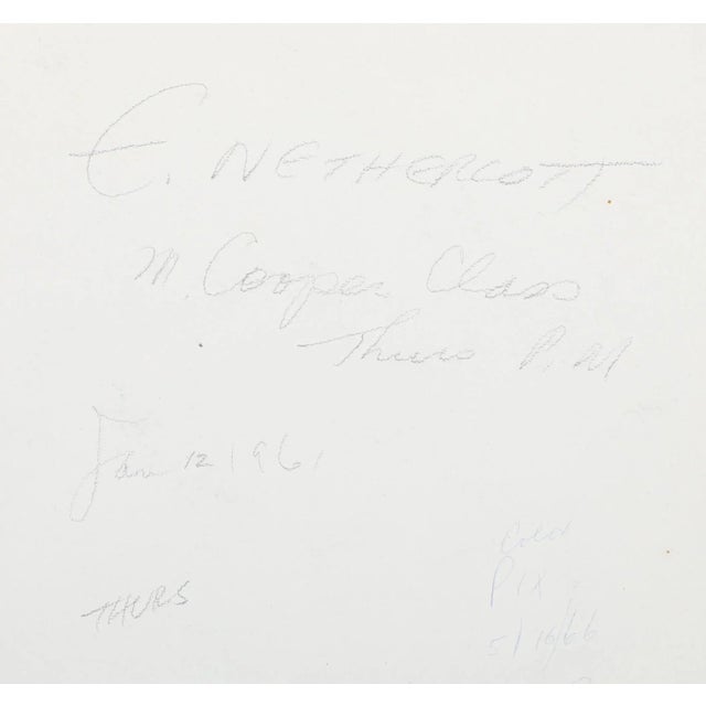 Sitting with a red tapestry wrapped loosely around the back of her chair, the topless woman with short black hair looks...