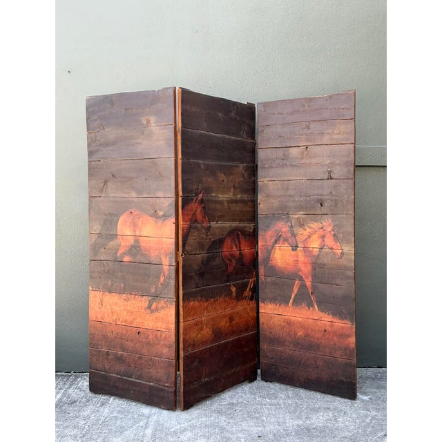 This striking three-panel folding screen is a captivating piece of Western Americana, expertly crafted from rustic...