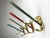 A beautiful set of four coat hooks from the 1950s made of gold-anodized and lacquered aluminum, where the multi-coloured...