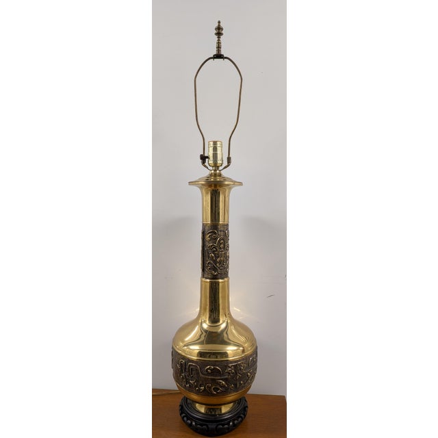 This striking 20th-century Asian brass table lamp brings an element of sophisticated vintage opulence and global flair to...