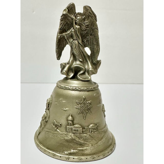 Pewter bell made in the USA in the late 20th Century. Handle is angel shaped with a raised nativity scenery along the...