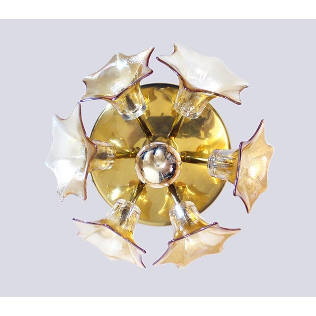 Elegant ceiling fixture with six iridescent amber murano glass flowers on a golden brass frame. Gem from the time. A real...