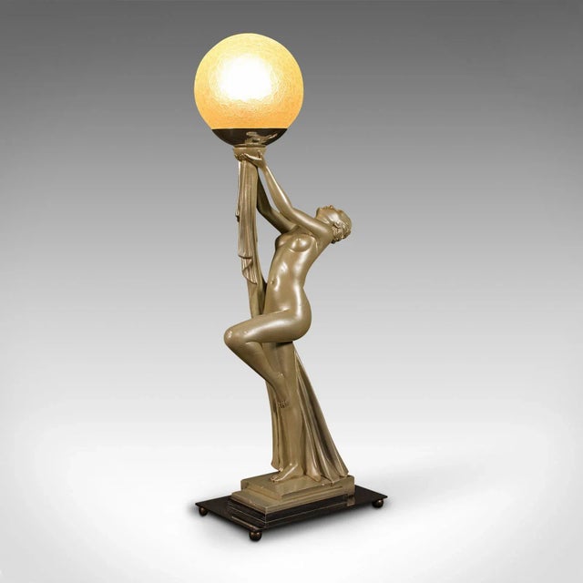 This is a vintage figural table lamp. An English, metallic plaster desk light in Art Deco taste by Leonardine, dating to...