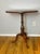 A finely crafted 19th century mahogany snake-foot tripod pillar table, executed in the English Regency tradition and...