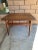 Mid century modern Danish square coffee table in teak featuring four rounded and tapered legs with four square stretchers....