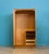 A mid century Uniflex wardrobe in warm teak veneer, with a clean front and recessed handles. Fitted with a mirrored door...