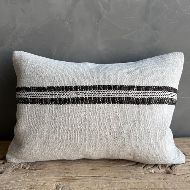 Creamy white hemp rug pillow with stripes. Soft hand, linen blend backing with zipper closure. Spot cleaning is...