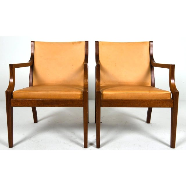 A pair of simply elegant Danish leather armchairs. The chairs could be used in either a formal or slightly casual setting....