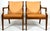 A pair of simply elegant Danish leather armchairs. The chairs could be used in either a formal or slightly casual setting....