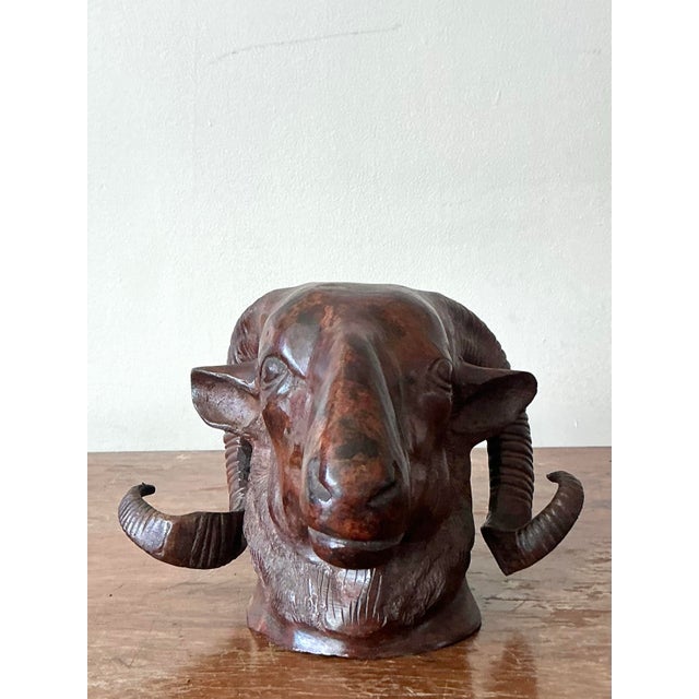 This compelling vintage cast bronze ram's head sculpture embodies a distinctive blend of rustic charm and artistic...