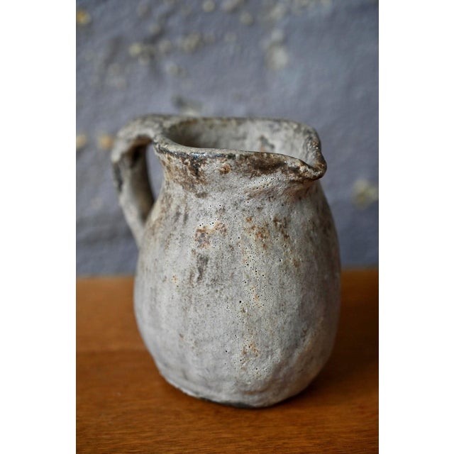 We absolutely love this superb handcrafted stoneware pitcher, a characterful piece typical of 1960s Brutalist design. We...