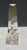 Optical topiary urn cut into a crystal obelisk to create, by reflection and illusion, an urn on pedistal with flowers...