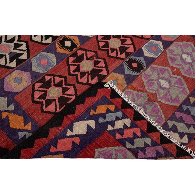 Beautiful kilim handmade wool runner with a red field. This Vintage flatweave rug features a gorgeous all-over geometric...