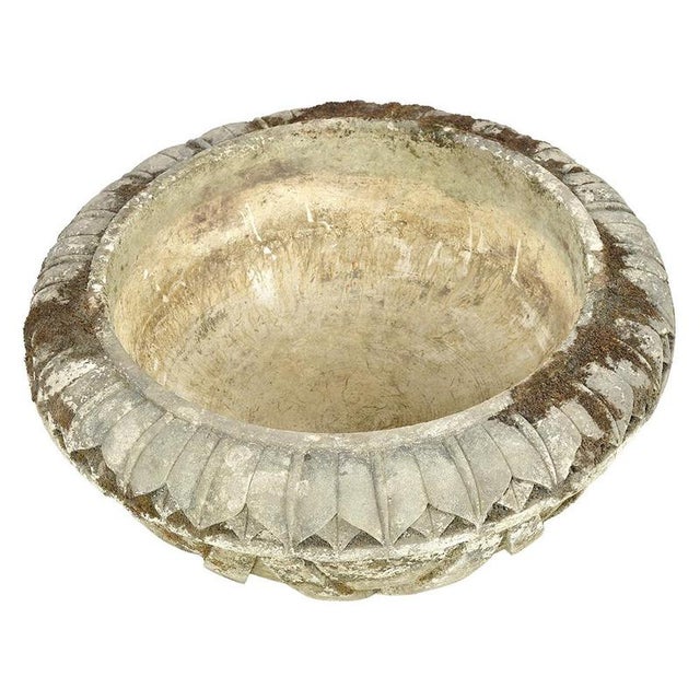 This stone basin, measuring 28 cm in height with a diameter of 60 cm, catches the eye with its relief ornaments evoking...