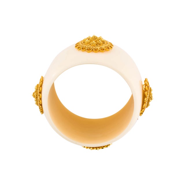 This resin cuff bracelet is attributed to Mallarino and is ornamented with intricate handmade 18k gold-plated filigree...