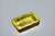 Rectangular Brutalist ceramic trinket dish with yellow and brown glaze and a crystallized glass base, signed GL (artist's...