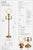A refined traditional torchiere floor lamp finished in a soft sunlit brass tone, featuring a classic glass uplight and...