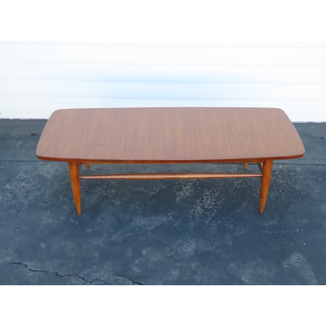This gorgeous Coffee Table is made out of wood, solid wood, walnut, and veneer. The Coffee Table has Mid Century Modern...