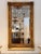 Large rectangular mirror with a richly molded giltwood frame accented by floral and foliate carvings. The surface shows a...