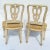 Pair of Italian carved ribbon back side chairs with gilded details and a spaded leg. Upholstered in Scalamandre fabric...