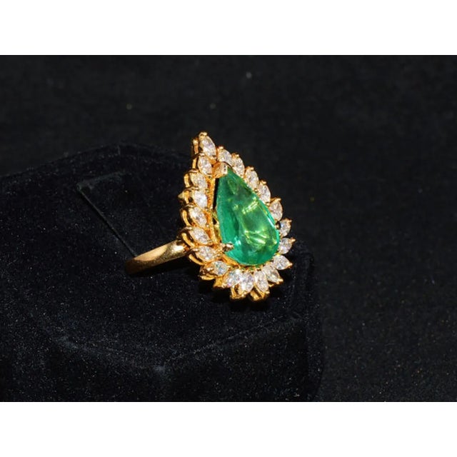 GIA certified 8.46CTS diamond & emerald 18K solid gold ring. This ring features a huge 6.81CT natural Zambian emerald. The...