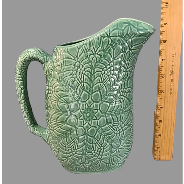 This handmade green ceramic pitcher is a beautiful addition to any collection. The ornate mandala pattern adds a unique...