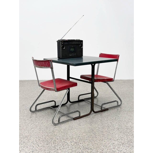 This rare set comprises two iconic aluminum chairs by cindy crawford-steiger for embru, along with a matching table...