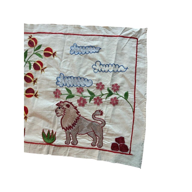 Hand-embroidered Suzani panel from Uzbekistan, worked in fine floss on a cream cotton ground. Three lions move across the...